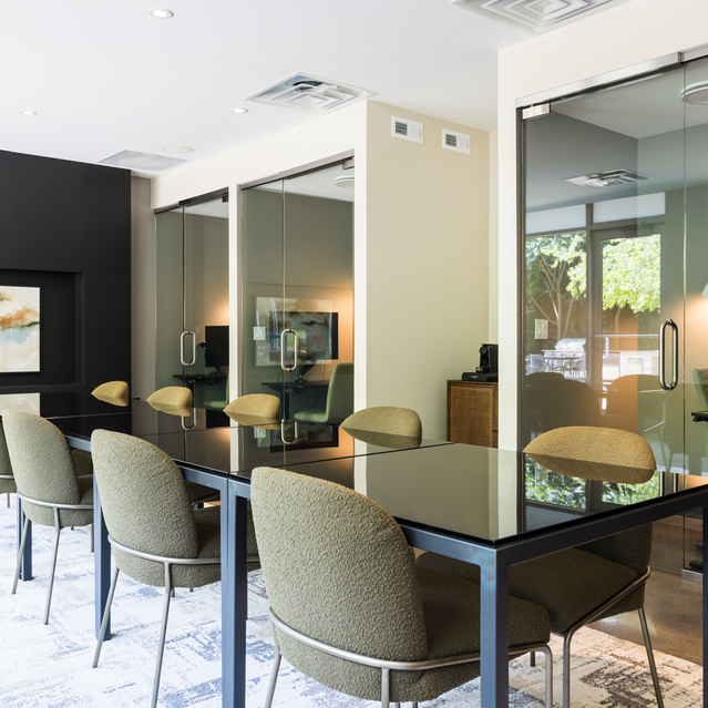 Mode Logan Square - Black Tables and Green Seats in Front of Artwork